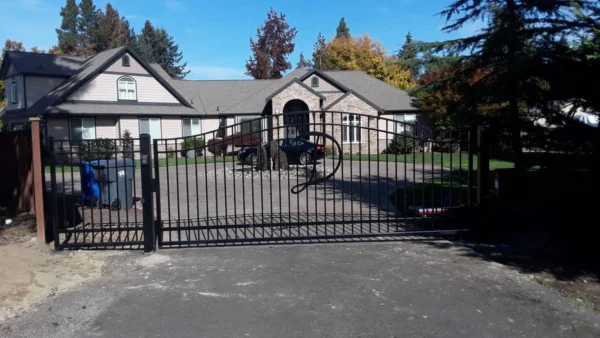 custom steel swing gate with capital letter decor