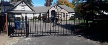 custom steel swing gate with capital letter decor